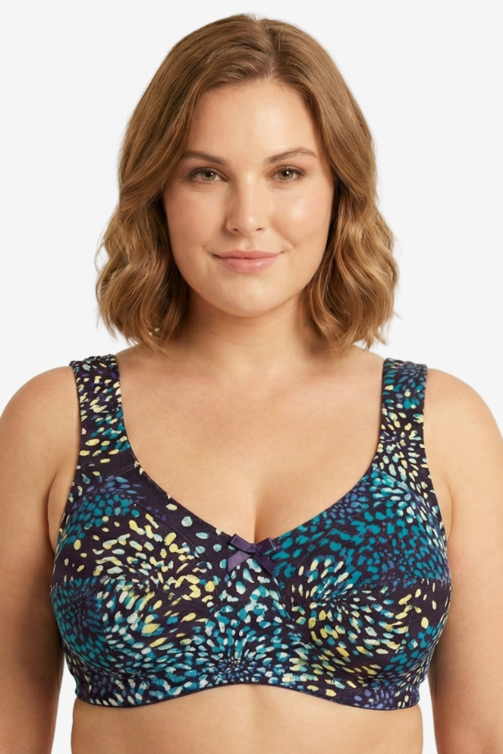 Woman wearing a patterned blue and black bralette against a beige background