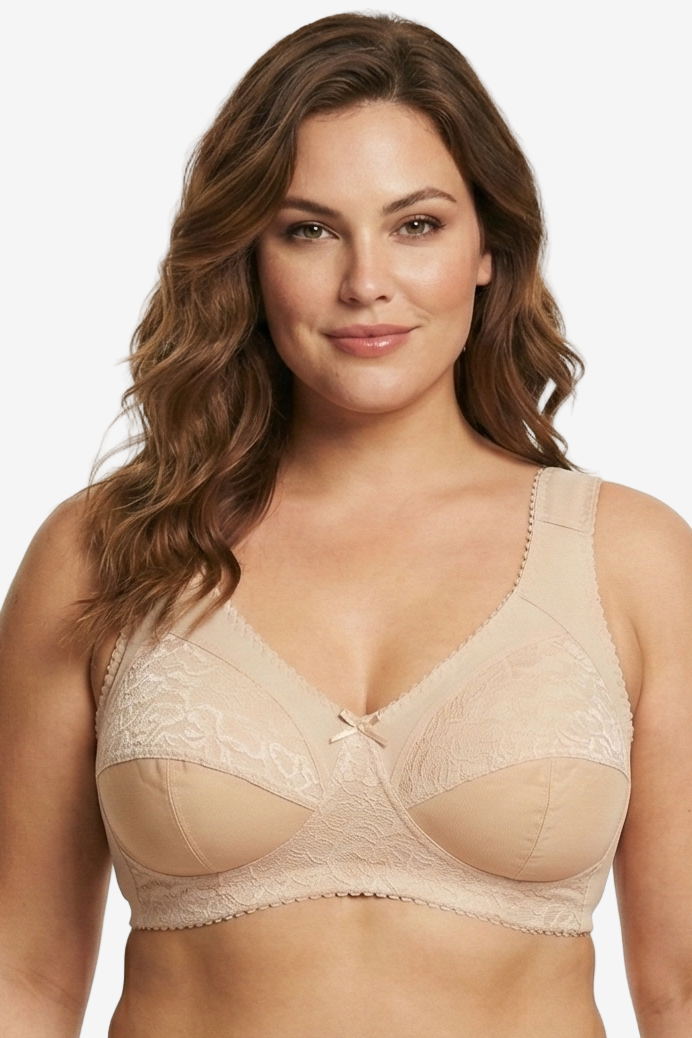 Woman wearing a beige bra and panties set on a white background
