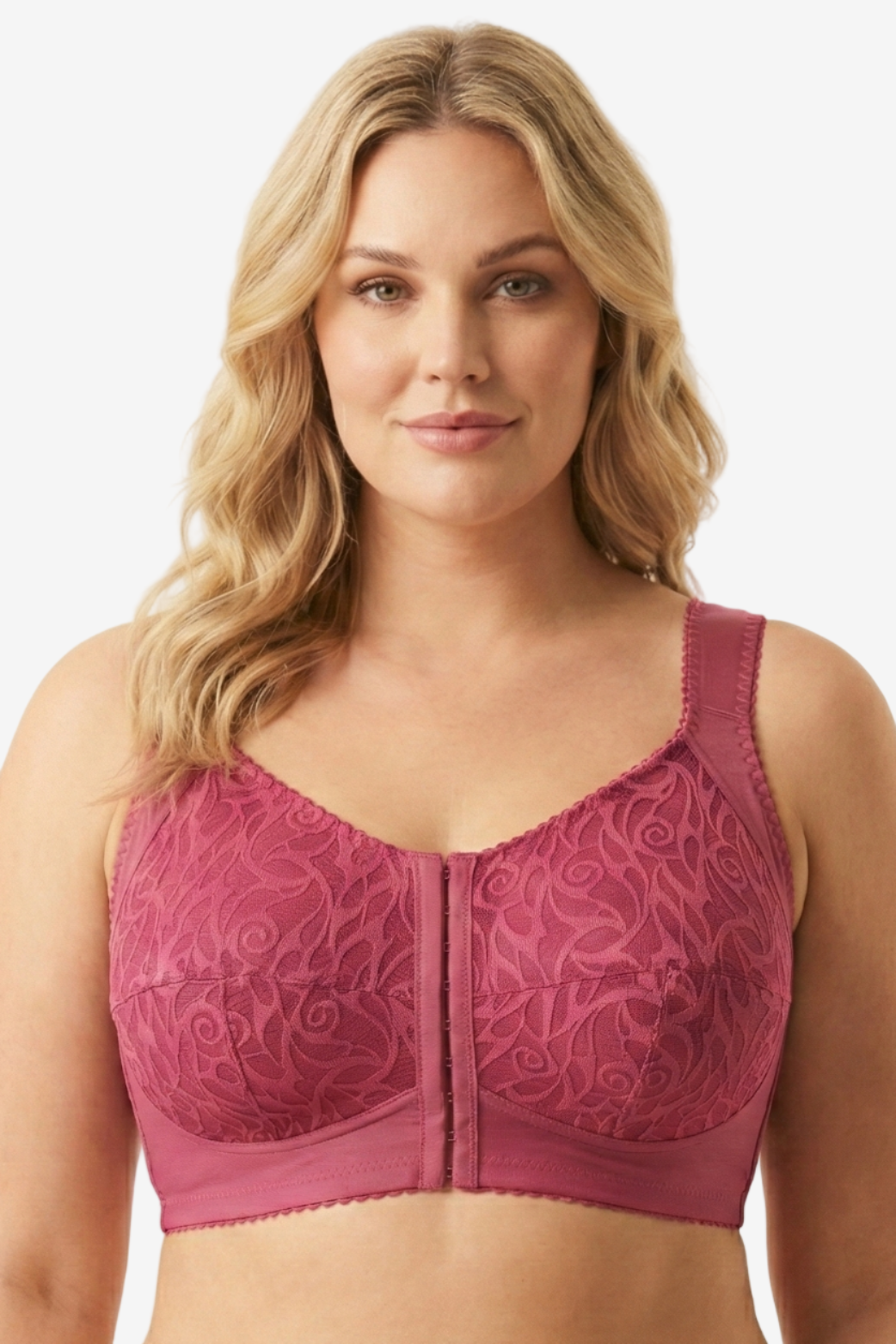 Woman wearing a pink lace bra against a beige background