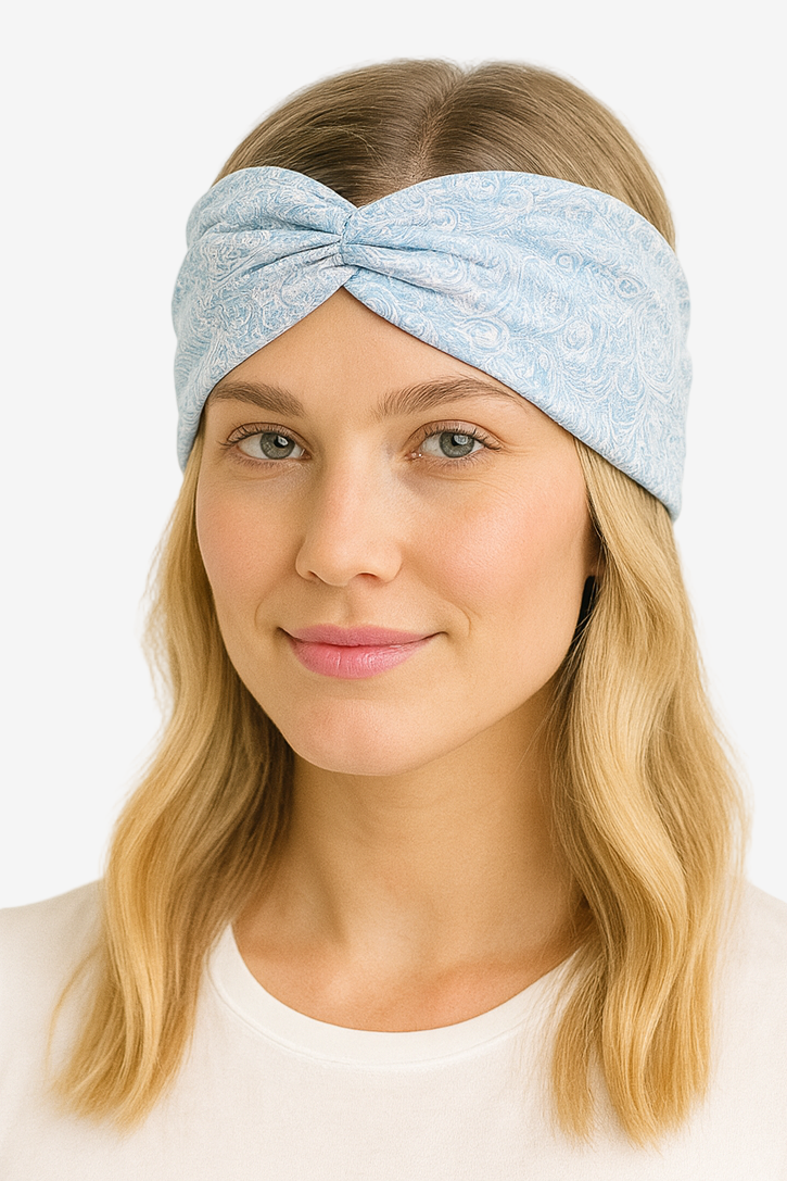 Woman wearing a light blue headband against a white background