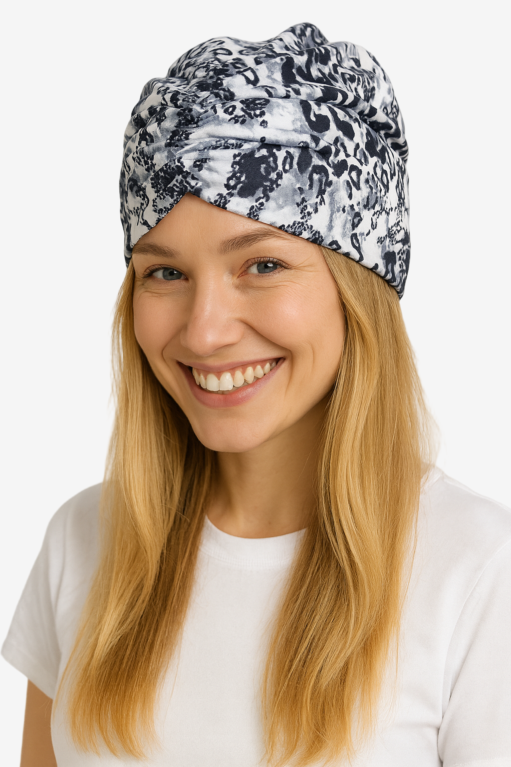 Woman wearing a patterned headscarf on a plain background
