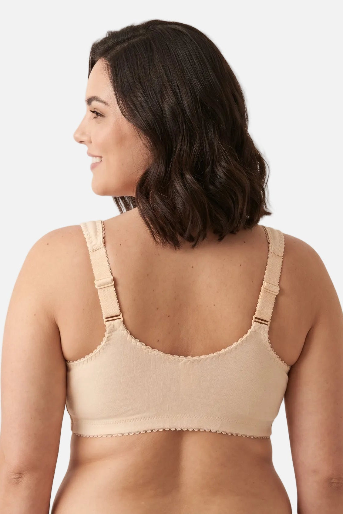 A woman shown from the back wearing a beige bralette against a plain light background.